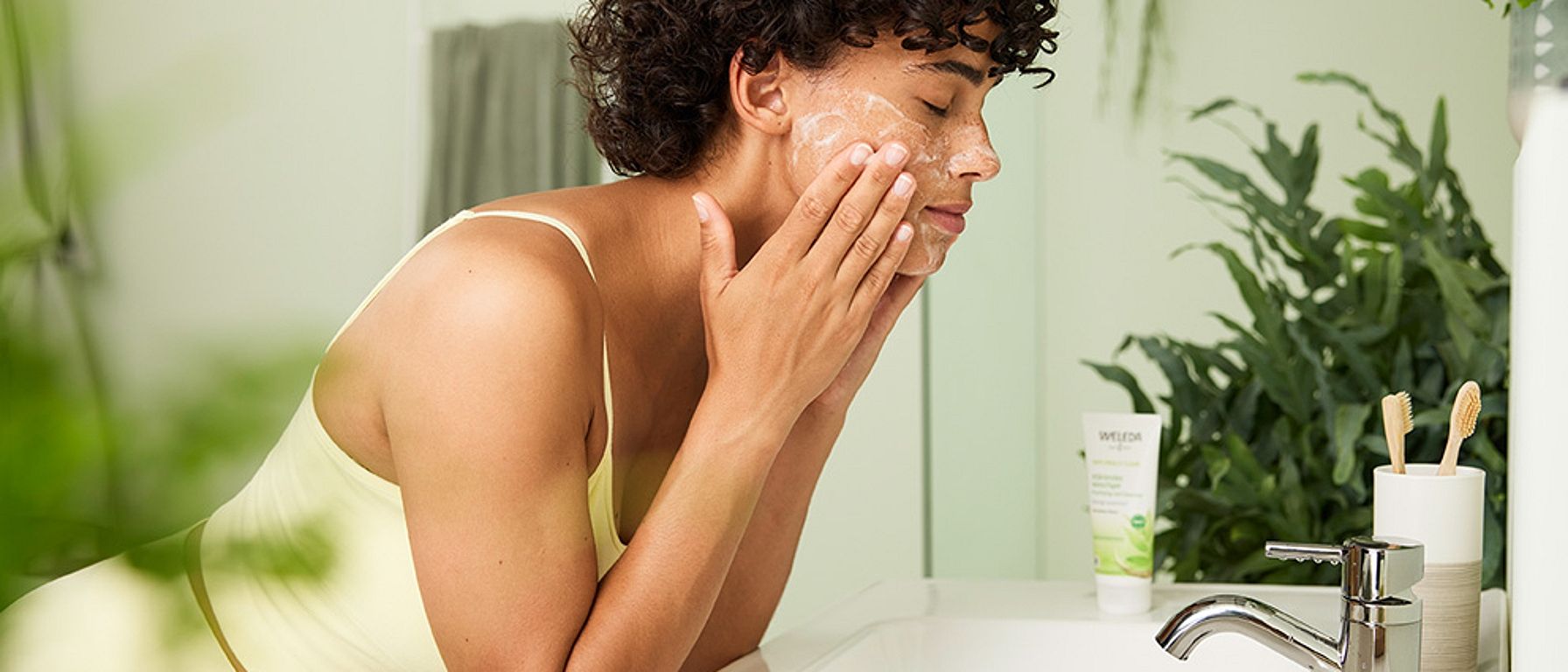 woman washing her face